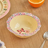 Rice By Rice Melamine Vintage Bowl - Pink Nathalie Lete Print - product shown on table with orange slice