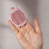 Odacite Face Cleansing Brush - model shown holding product