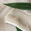 Sasawashi Mesh Body Scrub Towel - product shown with plant leaf on it