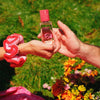 Kerzon Passiflore Eau de Parfum - models shown holding product near grass
