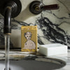 Archivist Hand Soap Bar - Shea Butter - product and packaging shown on sink with running water
