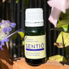 Neil Naturopathic Sentio Olfactory Support Essential Oil Blend - product shown next to flowers