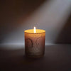 Parfum d'Empire Ambre Absolu Scented Candle - product shown lit in dark room