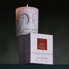 Lifestyle shot of Parfum d'Empire Ambre Absolu Scented Candle (200 g) shown lit sitting on box