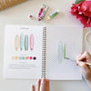 Emily Lex Studio Tropical Watercolor Workbook - model shown painting inside product
