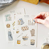 Emily Lex Studio Baking Sticker Sheet - model shown peeling product off sheet