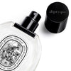 Close up of Diptyque Fleur de Peau Eau De Toilette (50 ml) with lid off showing spray bottle top