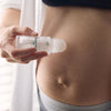 Mother Mother Magnesium Oil + Aloe Roller (1.7 oz) - product shown being applied to belly. 