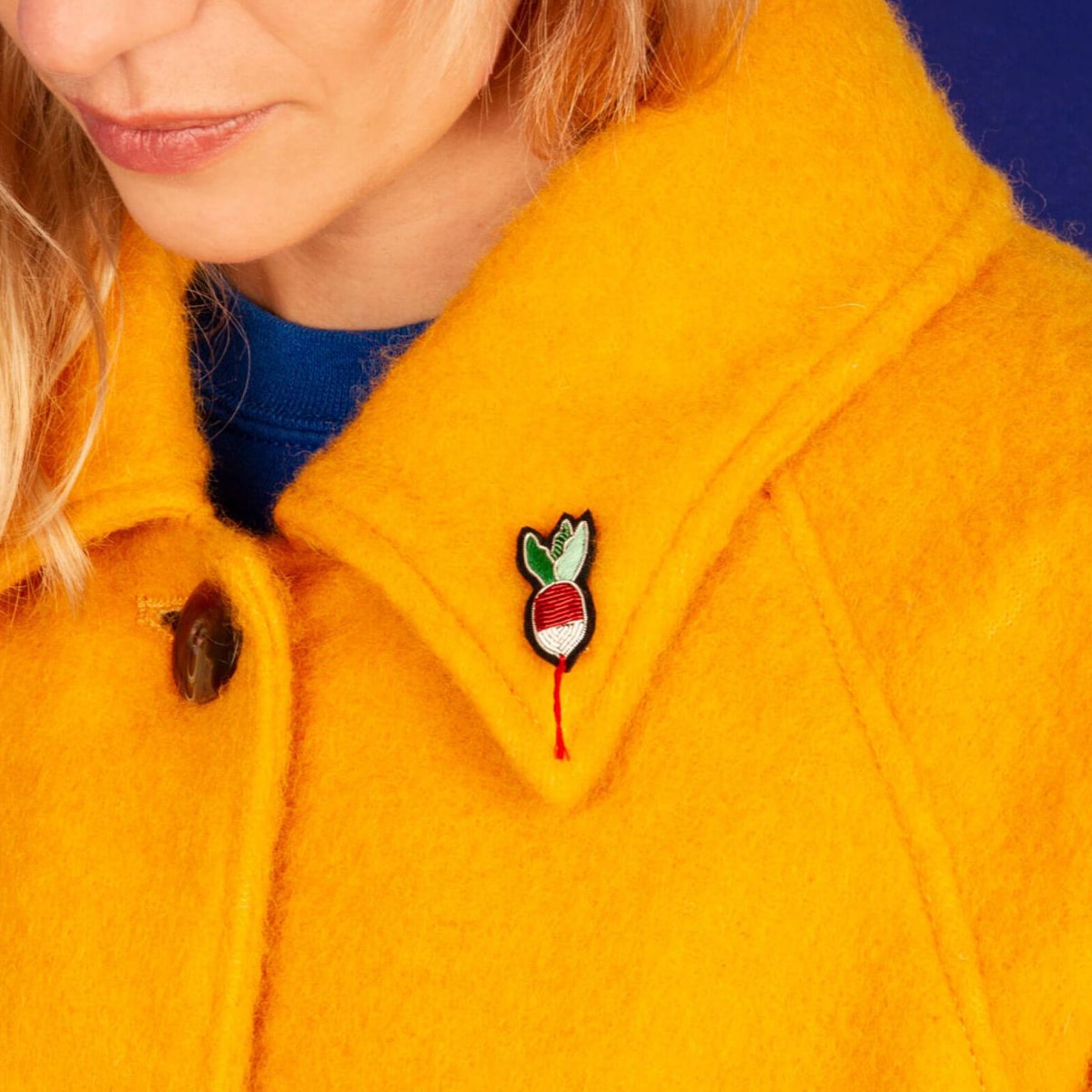 Macon & Lesquoy Hand Embroidered Small Radish Pin (1 pc) shown on lapel of woman's jacket