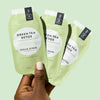 Model holding VOESH New York Mani Moments - Green Tea Detox packets