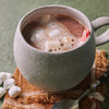 Coop’s Cocoa Felice Hot Chocolate Mix shown in mug with marshmallows and peppermint stick