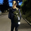 Firefly Reflectors Happy Flower Soft Shape - Yellow (1 pc) shown on backpack at night