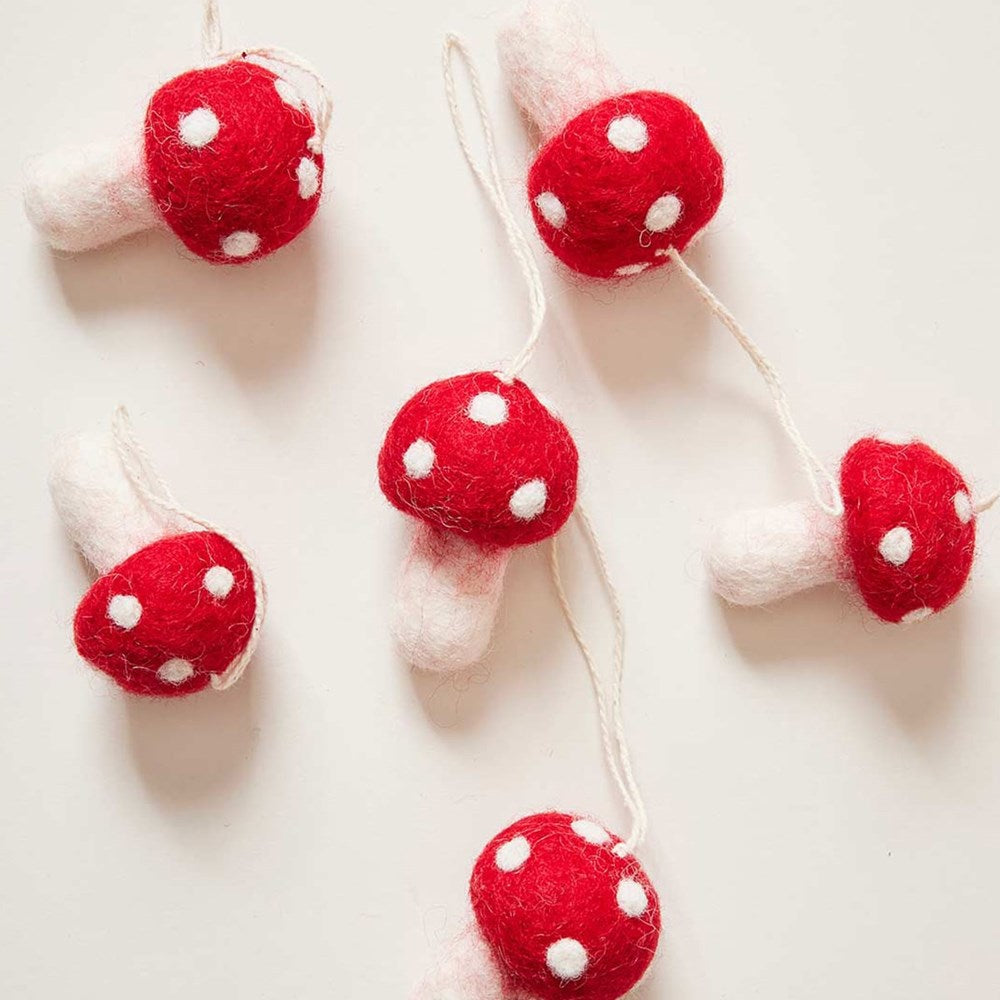 Farmhouse Pottery Nordic Felted Mushroom Ornaments shown lying next to each other 