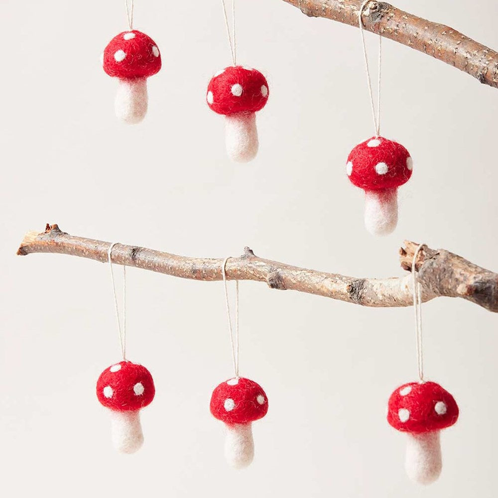 Farmhouse Pottery Nordic Felted Mushroom Ornaments shown hanging from tree branches