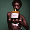 Flamingo Estate Green Goddess Candle (226 g) - product shown being held out by model. 