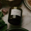Flamingo Estate Green Goddess Candle (226 g) - product shown on kitchen table. 
