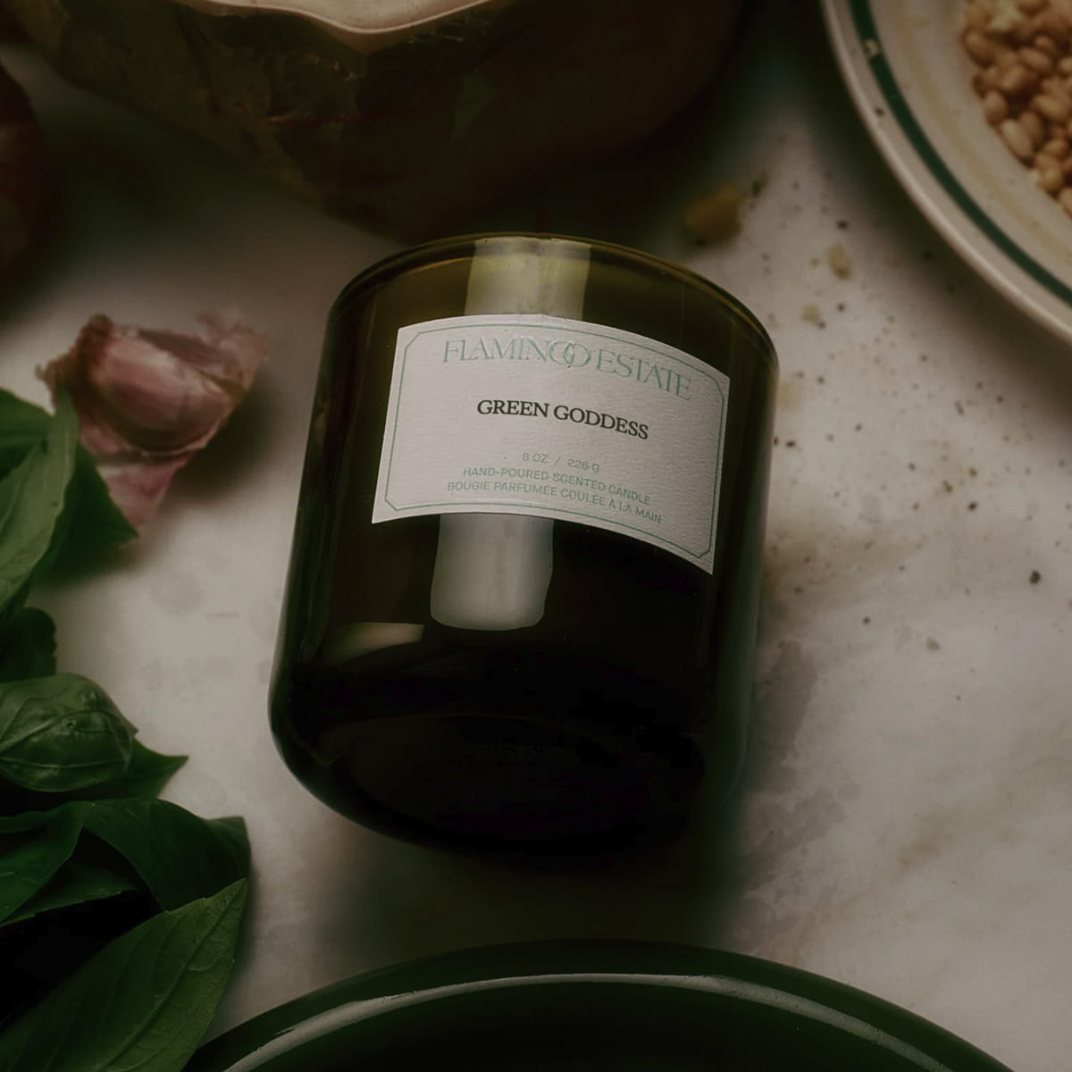 Flamingo Estate Green Goddess Candle (226 g) - product shown on kitchen table. 