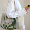 The Quiet Botanist Floral Tote Bag over the shoulder of model