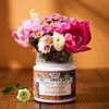 Confiture Mandarine Fragonard X Confiture Parisienne is shown with flowers from the top of the jar