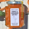 Lifestyle shot of Puckett’s Pickles Carrot & Cardamom Chutney (200 g) with carrot shavings in the background