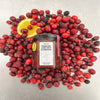 Puckett’s Pickles Cranberry, Redcurrant & Clementine (200 g) showing bottle on top of cranberries and redcurrants with a slice of lemon.