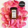 Puckett’s Pickles Rhubarb and Rose Water Jam (200 g) bottle shown surrounded by rose petals. Has seal that says great taste 2022