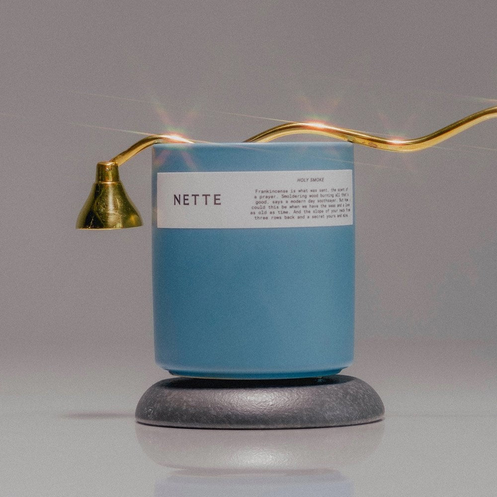NETTE Holy Smoke Scented Candle - shown with candle snuffer placed on top of candle
