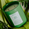NETTE x TATA HARPER Into the Forest Scented Candle - shown on side with leaves