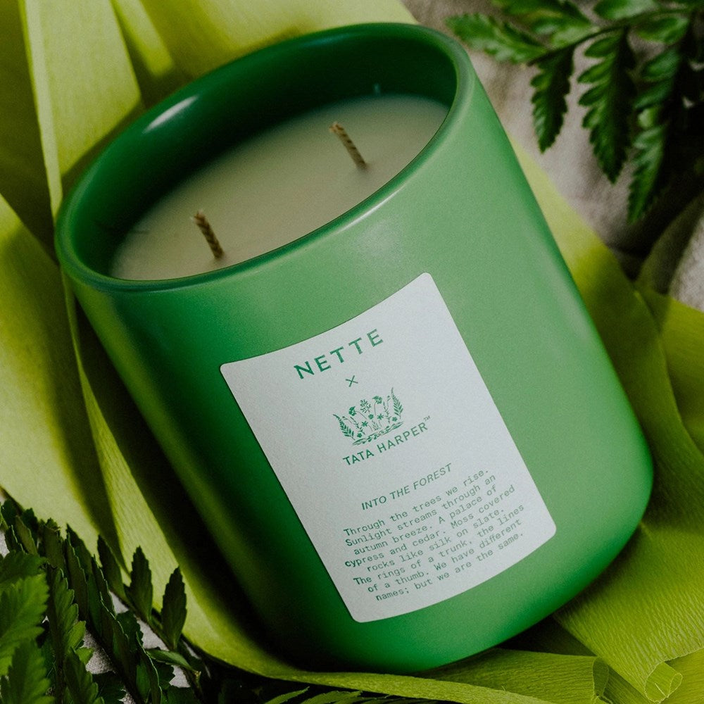 NETTE x TATA HARPER Into the Forest Scented Candle - shown on side with leaves