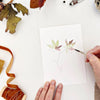 Emily Lex Studio Fall Leaves Paintable Notecards - product shown with paint brush and hands