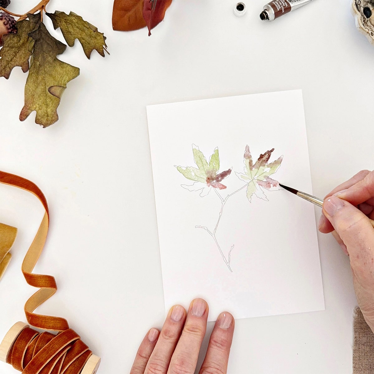 Emily Lex Studio Fall Leaves Paintable Notecards - product shown with paint brush and hands