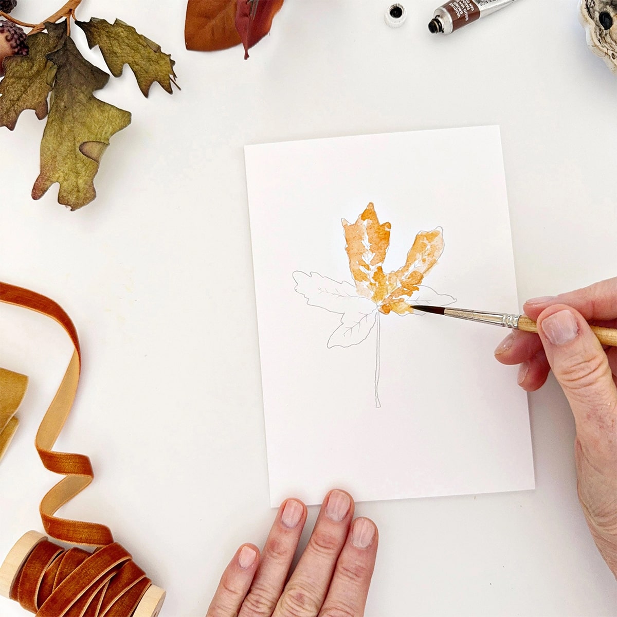 Emily Lex Studio Fall Leaves Paintable Notecards - product shown with paint brush and hands