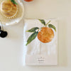 Emily Lex Studio Fruit Tea Towel - front of product shown next to fruit and scrub brush