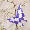 Cambridge Imprint Origami Cloud of Butterflies Kit (36 pc) hanging from a branch with flowers.