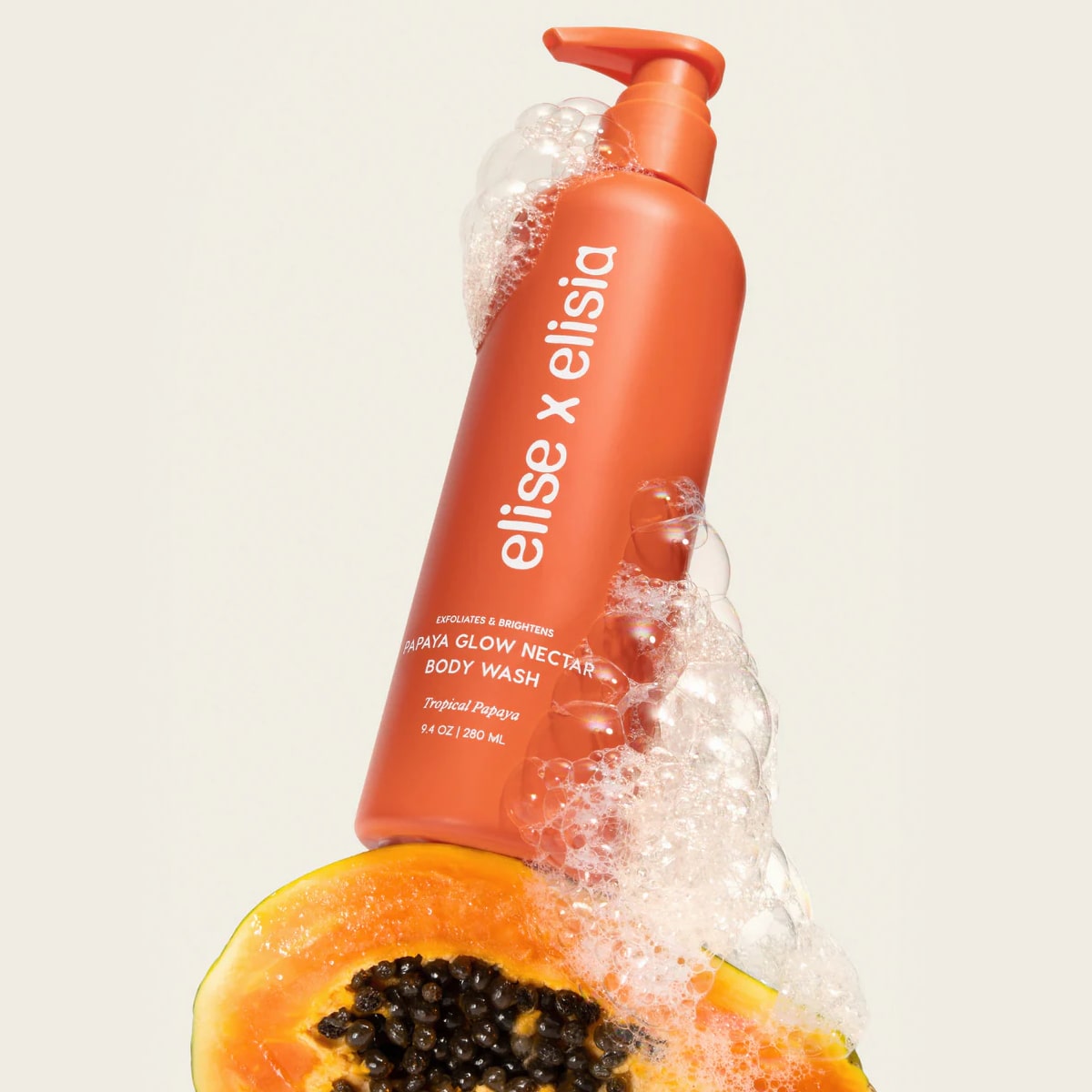 Elise x Elisia Papaya Glow Nectar Body Wash (9.4 oz) with suds on half a papaya 