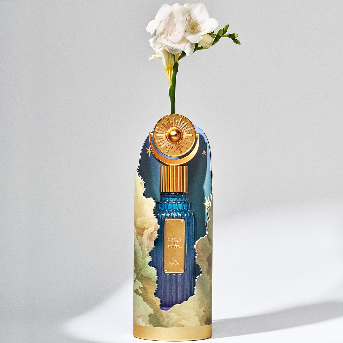Cirque du Soleil L’eau de Parfum - front of product shown from inside of box with a flower on top