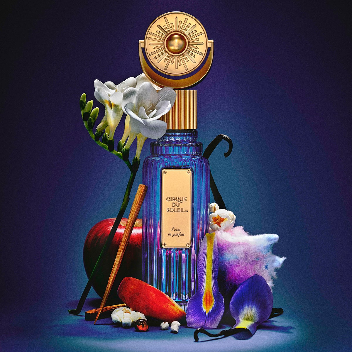 Cirque du Soleil L’eau de Parfum - product shown with flower leaves, apple, popcorn, cotton candy and vanilla bean
