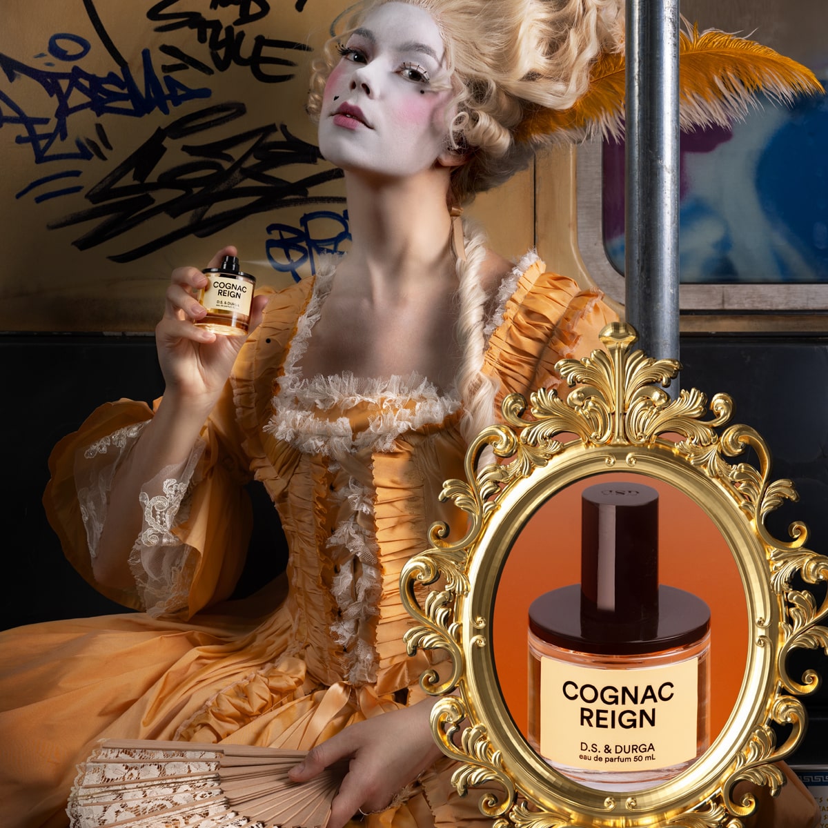 Woman in vintage-style dress holding a bottle of D.S. & Durga Cognac Reign perfume (50 ml)
