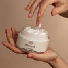 Odacite C-Nourish Hydra-Firm Body Cream (6 oz) - product shown in hand and product smear on fingertip 
