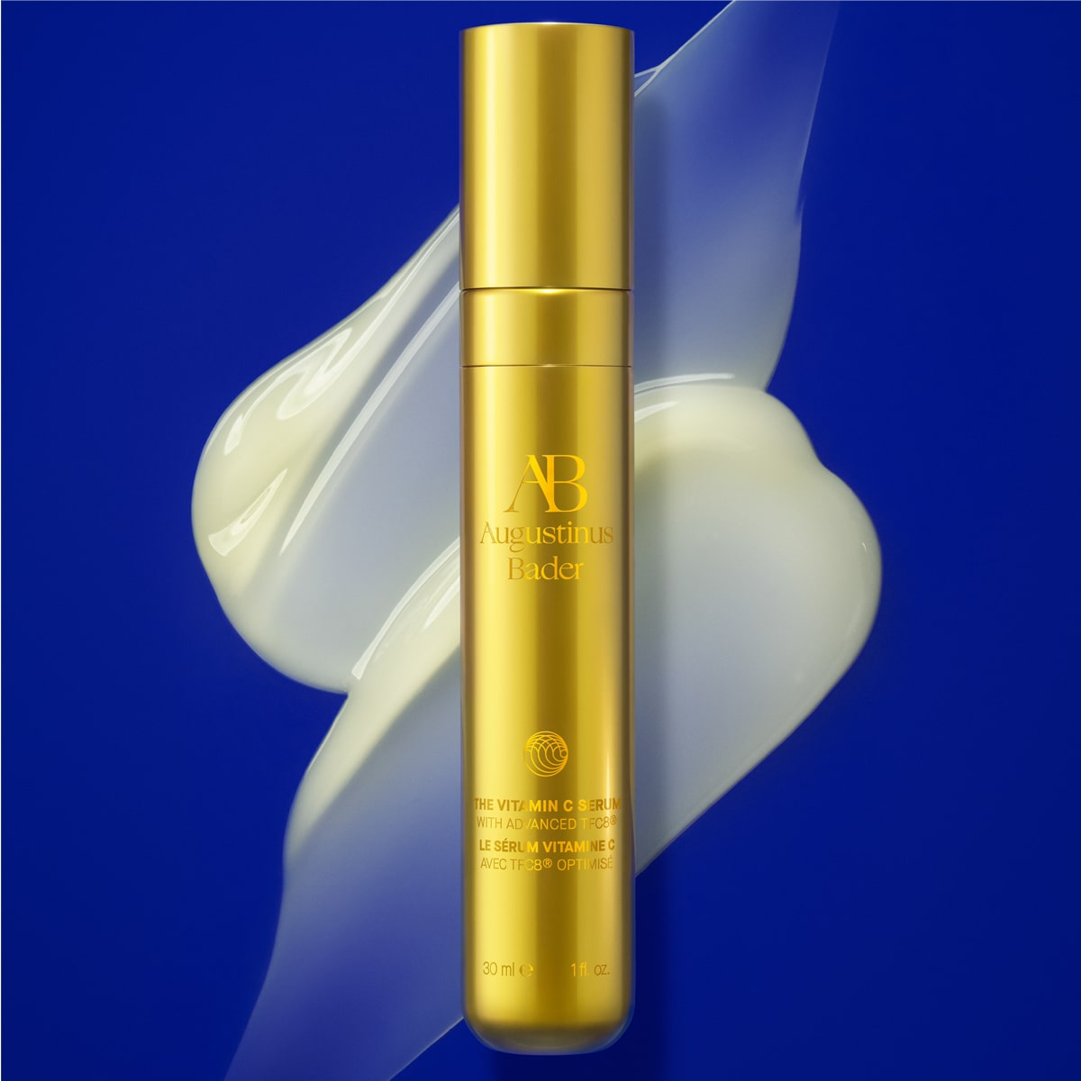 Augustinus Bader The Vitamin C Serum (30 ml) - product smear shown behind product on blue background 