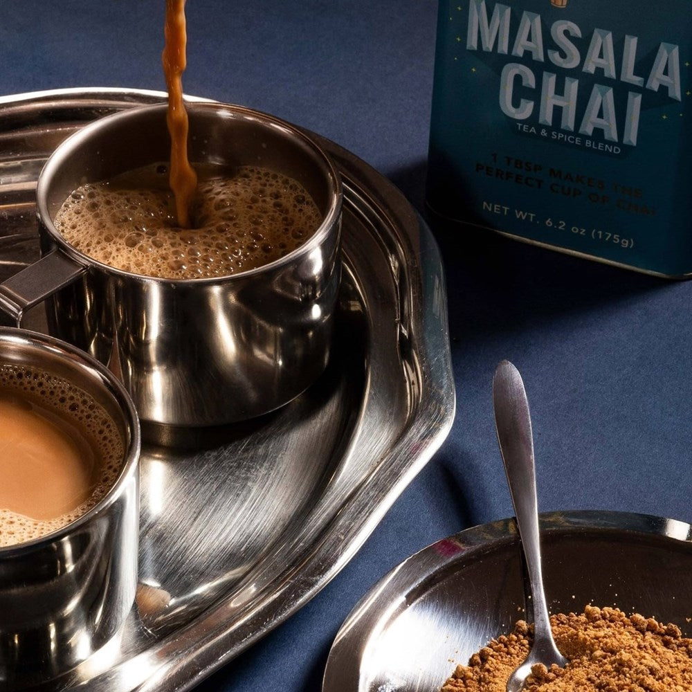 Diaspora Co Masala Chai (6.2 oz) - product shown in jar and with spoon in dish and cup of coffee being poured into cup