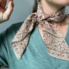 Peaceware Apple Cider Bandana (1 pc) - Person wearing product tied around neck. 