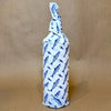Wildly Virgin Joaquim’s Reserve Olive Oil (16.9 oz) & Pour Spout (1 pc) - Product shown wrapped in blue and white paper.