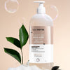 Solinotes Tonka Shower Gel (33.8 oz) with leaves and bubbles on a beige background