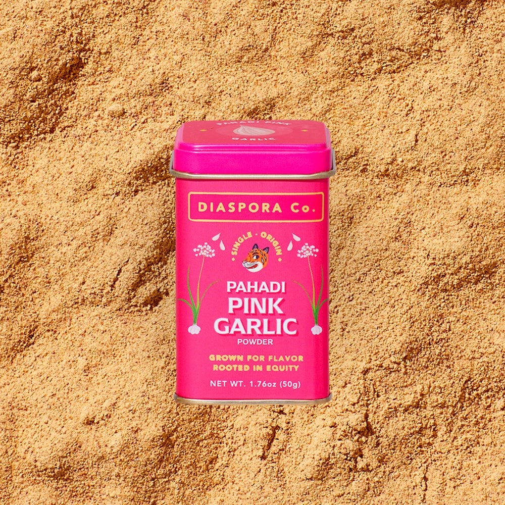 Diaspora Co. Pahadi Pink Garlic (2.11 oz) tin with Pahadi Pink Garlic powder in the background