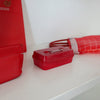 Hightide Tiny Container - Red (1 pc) - Product shown next to other red objects on white surface. 