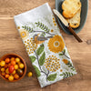 Close up of Gingiber Mums & Robins Tea Towel (1 pc) shown folded with food in the background