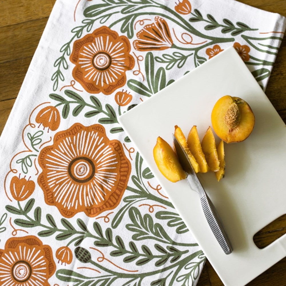 Peach on cutting board with close up of Gingiber Poppy Tea Towel (1 pc)