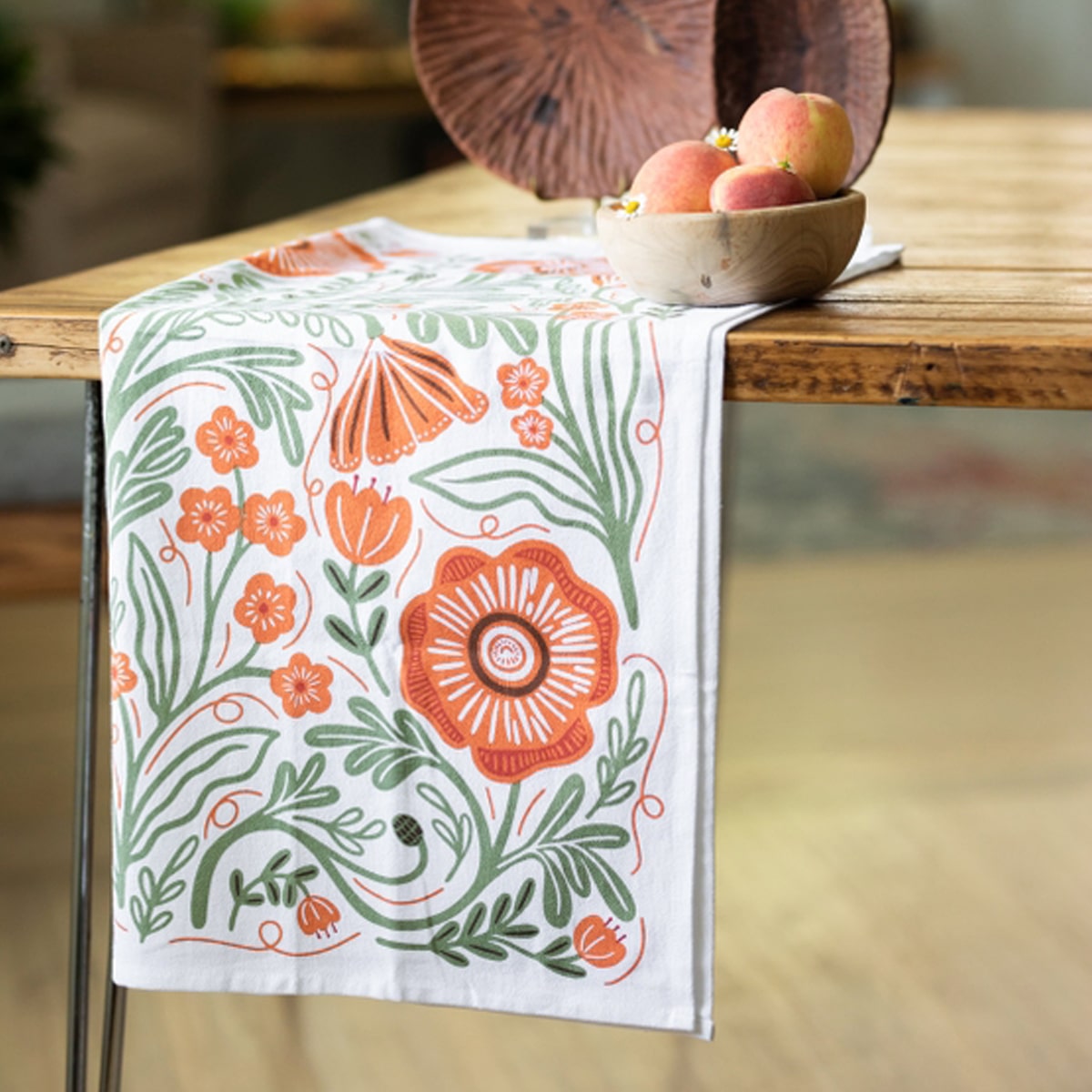 Close up of Gingiber Poppy Tea Towel (1 pc) shown folded on wood table