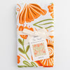 Close up of Gingiber Poppy Tea Towel (1 pc) shown folded with Gingiber linen bow and tag